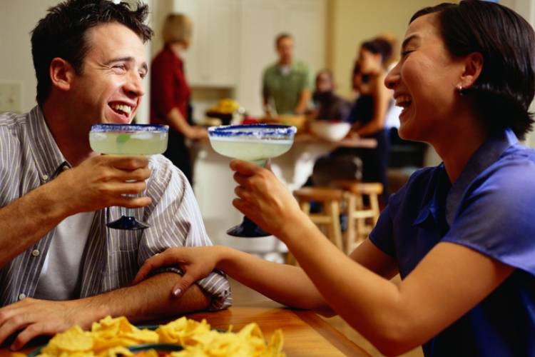 couple laughing over margaritas