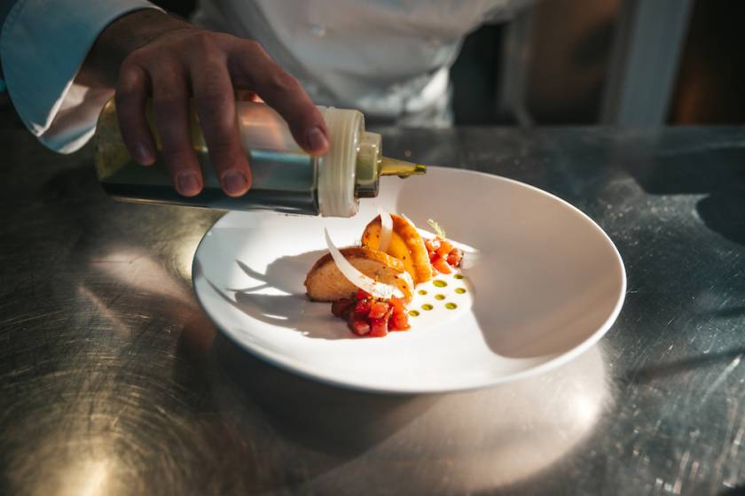 chef plating food at fine dining restaurant